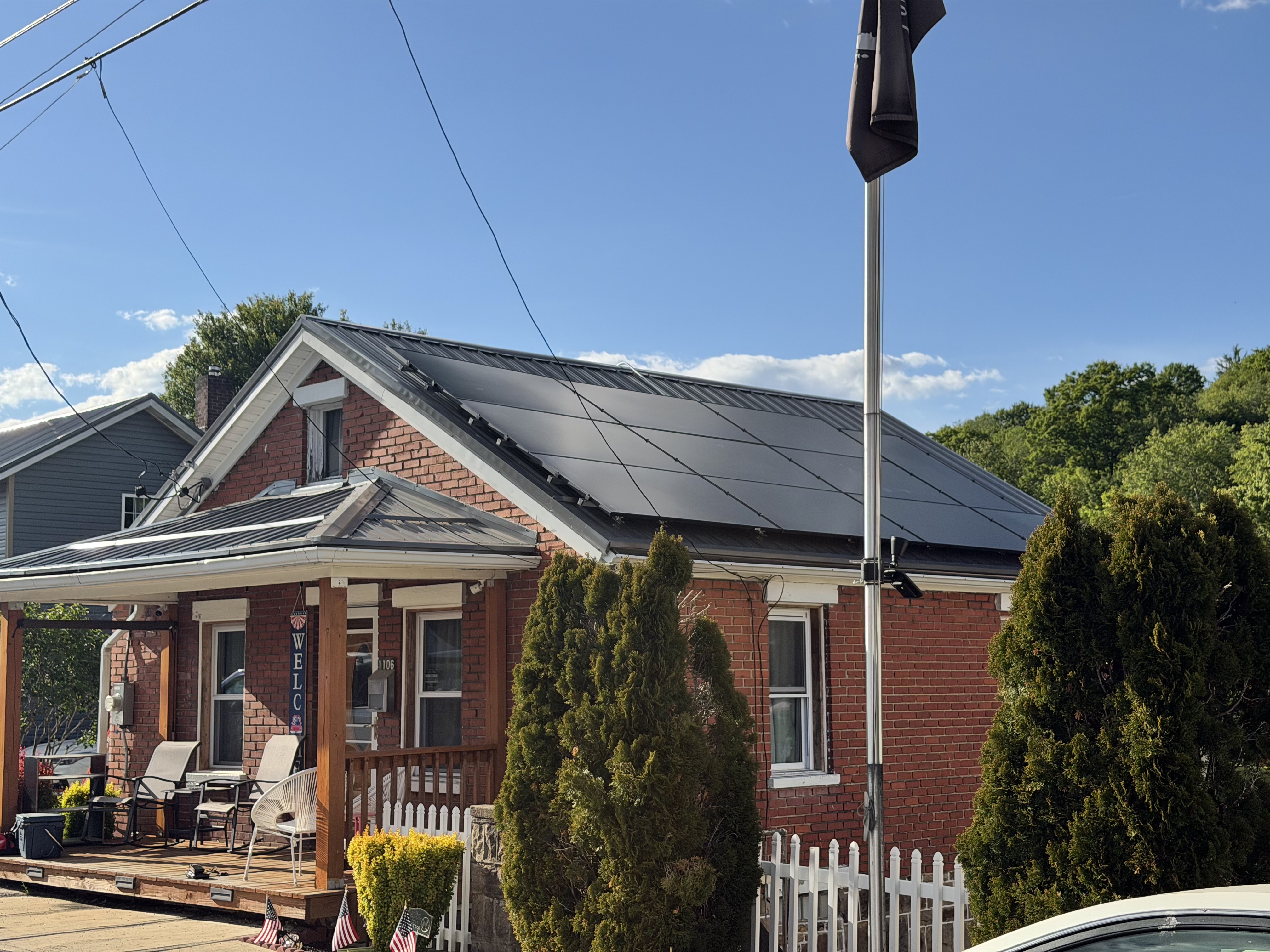 A rooftop solar installation on a familiar brick home.